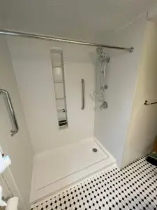 A new walk-in shower with white walls