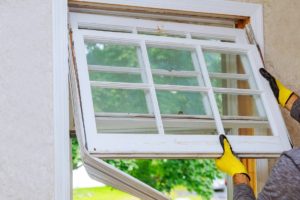 Double-hung replacement windows being installed