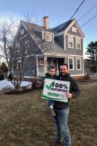 Peter and his son, Charlie, outside their home, newly sided by NEWPRO. Holding a 100% satisfied